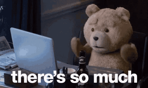 a teddy bear is sitting at a desk in front of a laptop computer and says there 's so much .