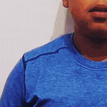 a close up of a man 's face wearing a blue t-shirt .