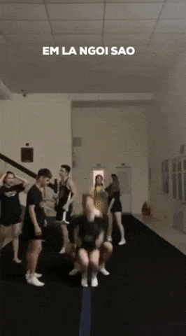 a group of people are dancing in a room with the words em la ngoi sao written on the bottom .