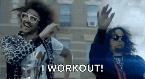 two men are dancing in front of a building and one of them is wearing sunglasses and a leopard print jacket .