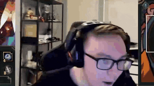 a man wearing glasses and headphones is sitting in a chair .