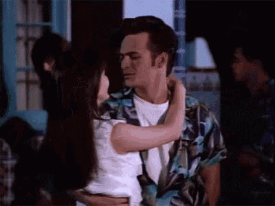 a man and a woman are dancing together in a room .