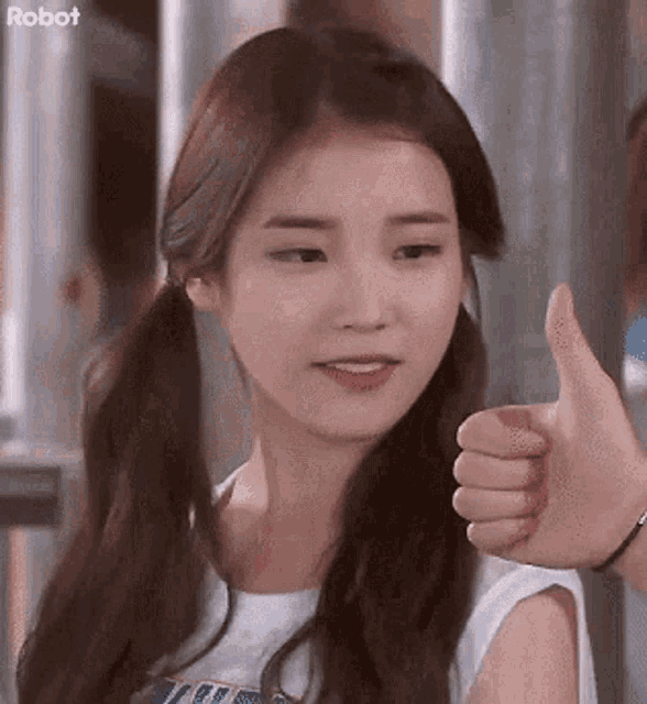 a girl with pigtails is giving a thumbs up and the word robot is on the bottom