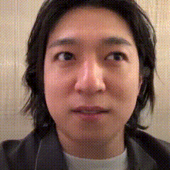 a close up of a person 's face with a polka dot background
