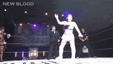 a woman in a wrestling ring with the words new blood written above her