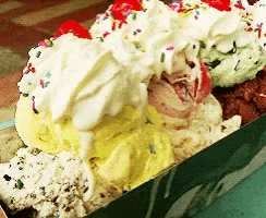ice cream with whipped cream and sprinkles in a box