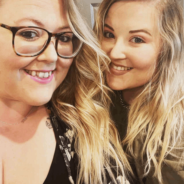 two women are posing for a picture and one has glasses