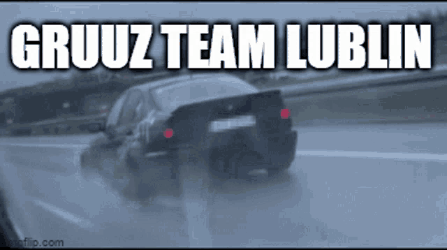 a car is driving down a highway in the rain with the words gruuz team lublin written on it