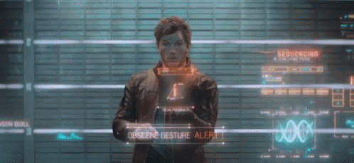 a man stands in front of a screen that says ' orscene gesture alert ' on it