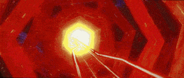 a person is flying through a red tunnel with a light coming out of the middle .