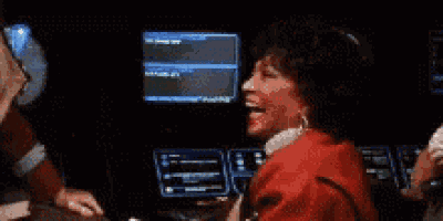 a woman in a red dress is sitting in front of a computer screen with the words # 200 % done with your shit above her .