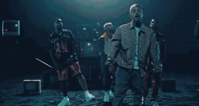 a man wearing a leopard print jacket is standing in front of a group of men