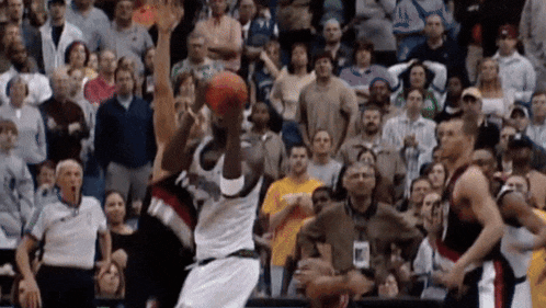 a basketball player with the number 11 on his shirt is jumping for the ball