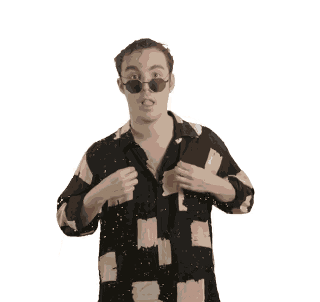 a man wearing sunglasses and a shirt with a geometric pattern