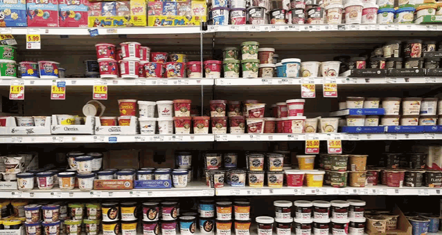 a grocery store shelf filled with lots of yogurt cups and boxes