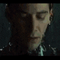 a close up of a man 's face with rain drops falling on it .