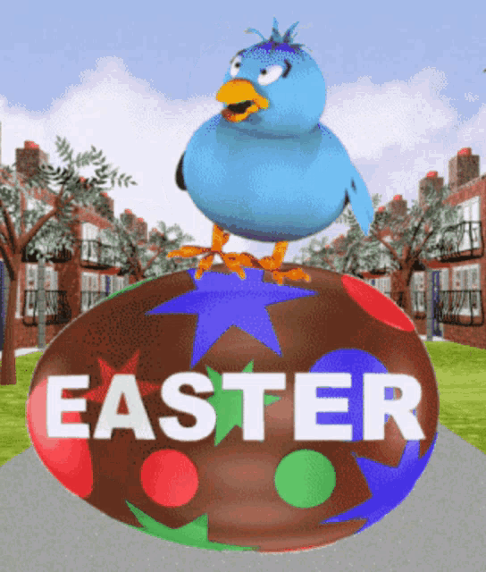 a blue bird standing on top of an easter egg