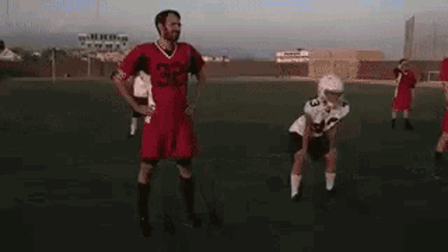 a group of football players are standing on a field and one of them is wearing a number 29 jersey .
