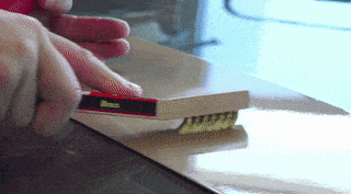 a person is cleaning a piece of wood with a brush that says ibanez on it