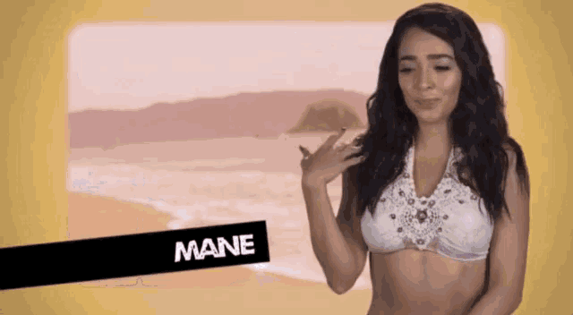 a woman in a bikini is standing in front of a beach with the name mane