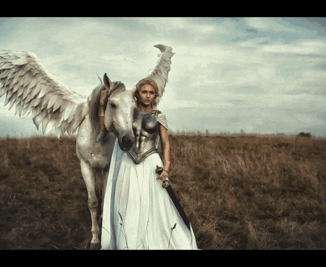a woman in a white dress stands next to a white horse with angel wings