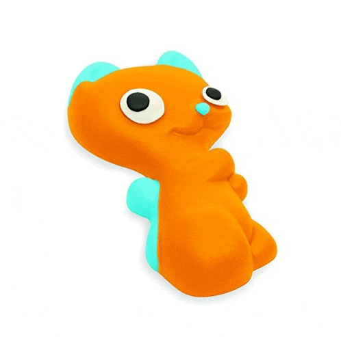 a stuffed animal with big eyes and a blue tail is sitting on a white background .