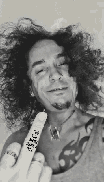 a man with a tattoo on his finger that says " go too mars draw my dick "