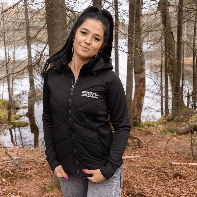 a woman wearing a black jacket with the word fxr on the front