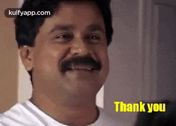 a man with a mustache is smiling with the words `` thank you '' written below him .