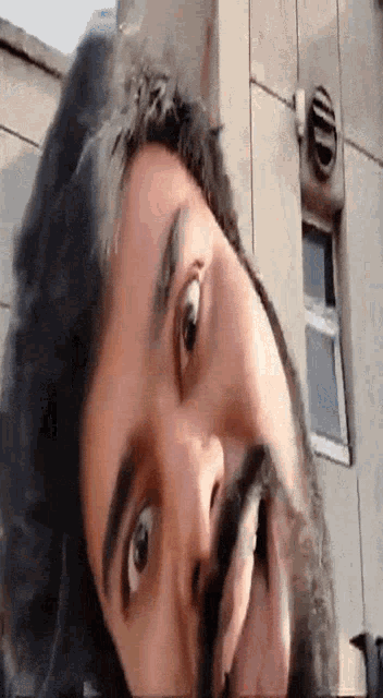 a close up of a man 's face with his tongue out