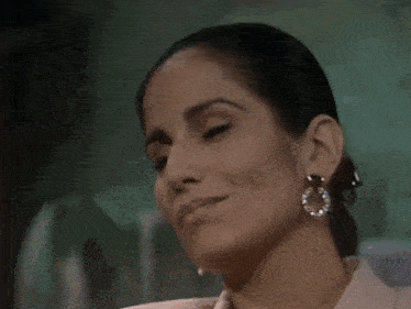two women are looking at each other with their eyes closed