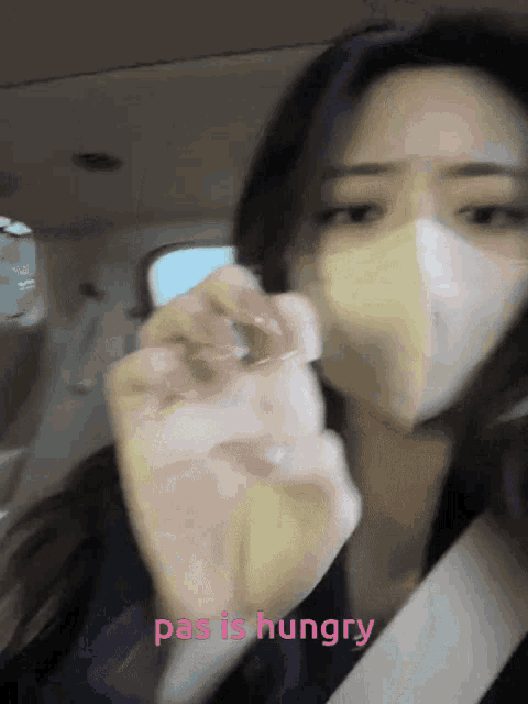 a woman wearing a mask says pas is hungry in pink
