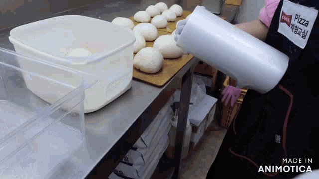 a person wearing a pizza hut apron is holding a roll of plastic wrap