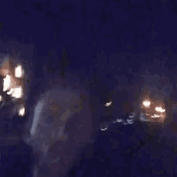 a blurry picture of a person 's face in a dark room .