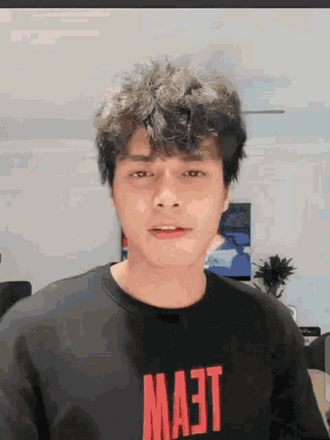 a man wearing a black shirt that says ma3t on it