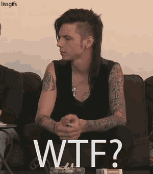 a man with a mohawk is sitting on a couch with the words wtf written on it