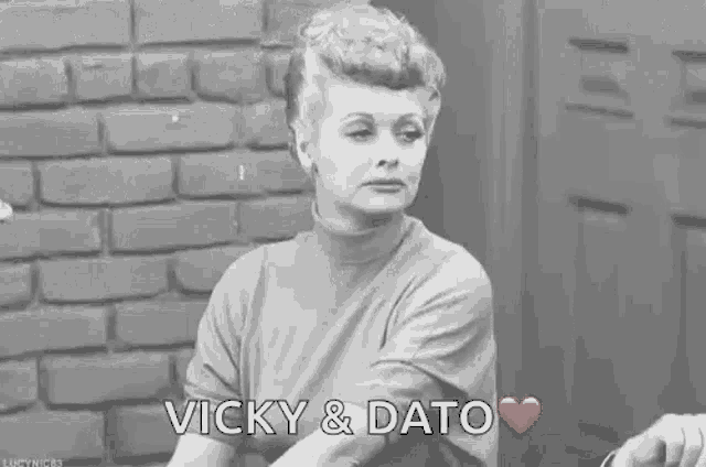 a man in a suit and tie is sticking his tongue out and says vicky & dato