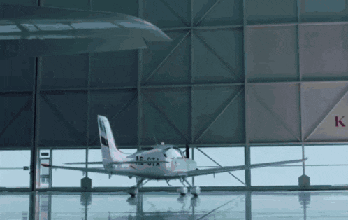 a small plane in a hangar with the letters k on the side