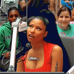 a woman sitting in front of a microphone with uhm on her chest