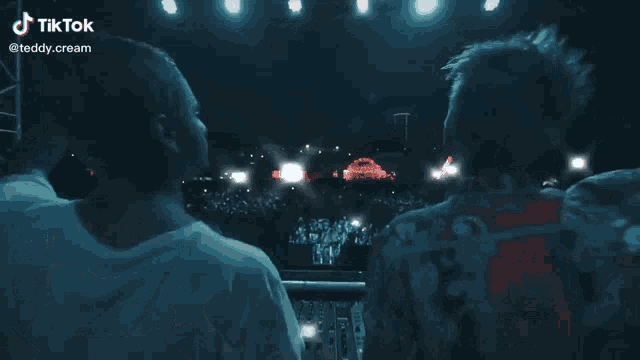 two men are standing in front of a stage with a tiktok watermark