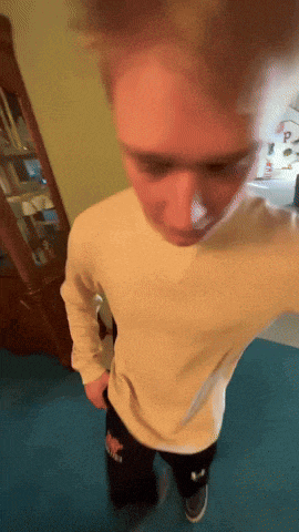 a person wearing a white shirt and black pants with the letter p on them