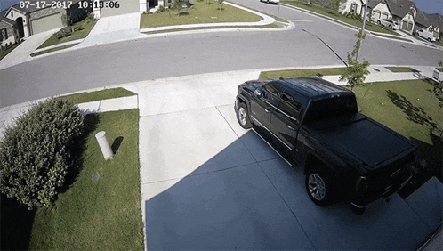 a black truck is parked in a driveway with the date of 07-12-2017