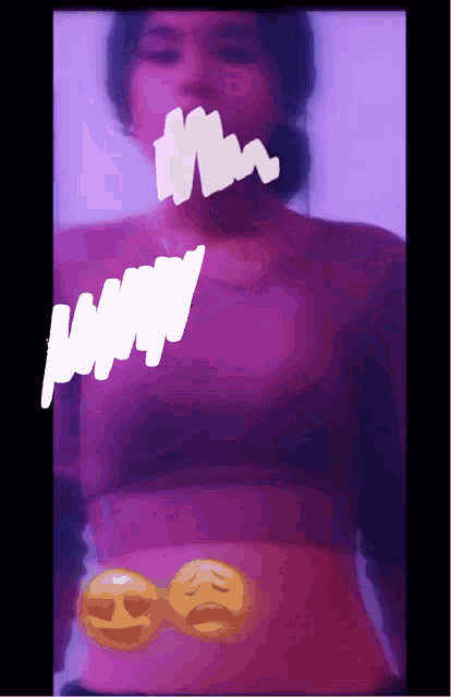 a girl in a purple shirt has a drawing of a smiley face on her stomach