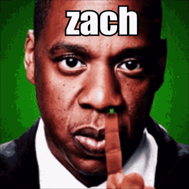 a man holds his finger to his mouth with the name zach above him