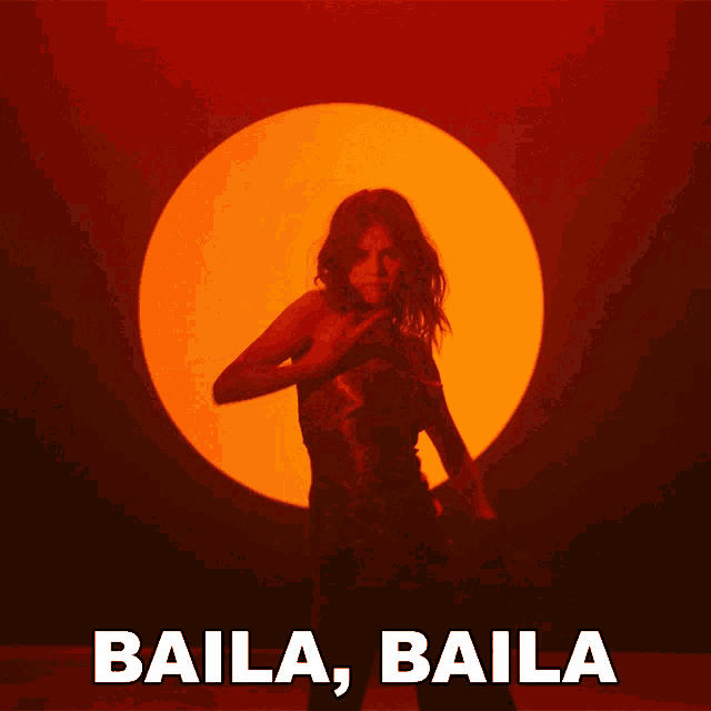 a woman in a red dress is dancing in front of a sun and the words baila baila below her