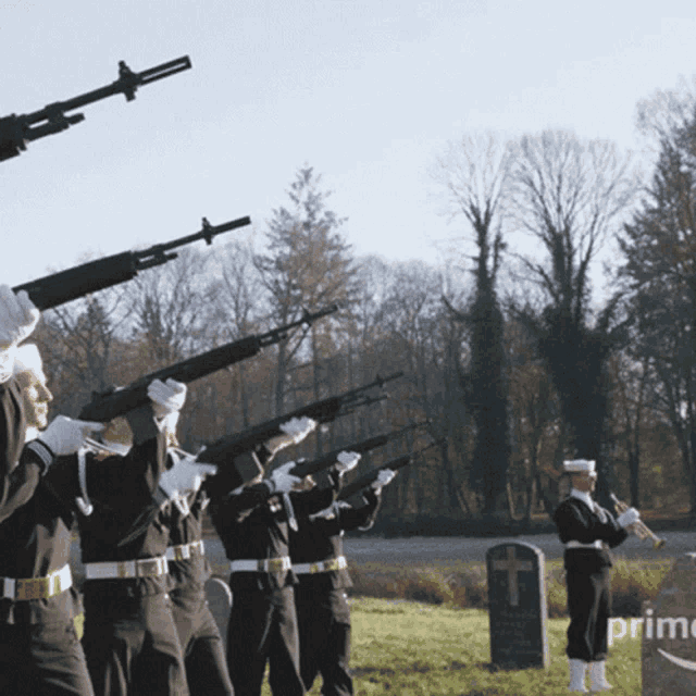 a group of men holding guns in front of a gravestone that says prime on it