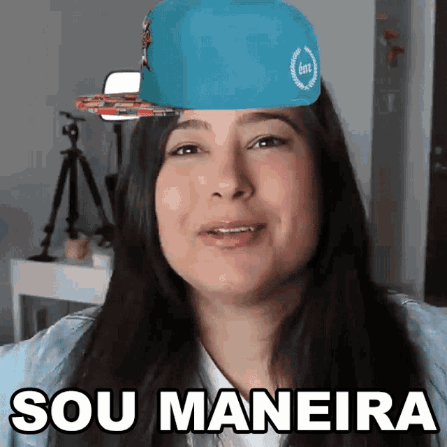 a woman wearing a blue hat with the words sou maneira on the bottom