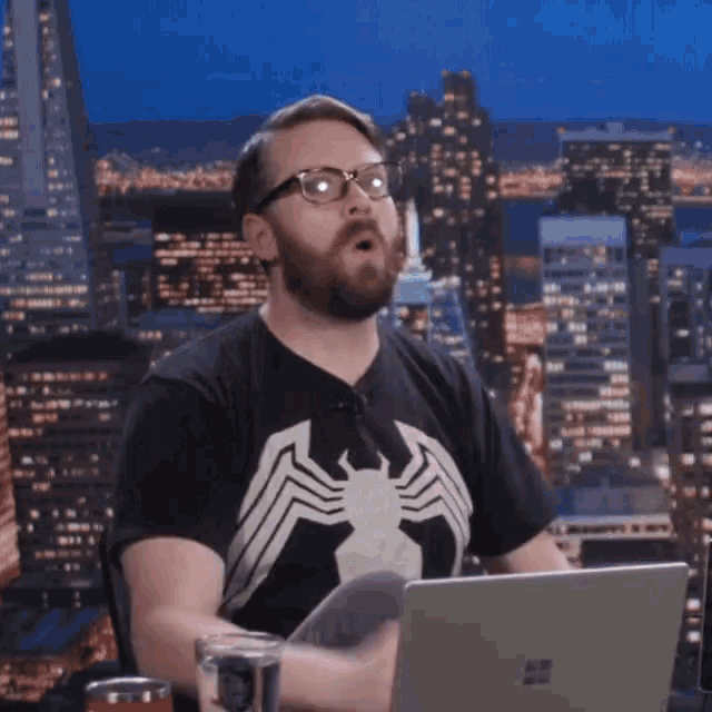 a man wearing a black shirt with a spider web on it