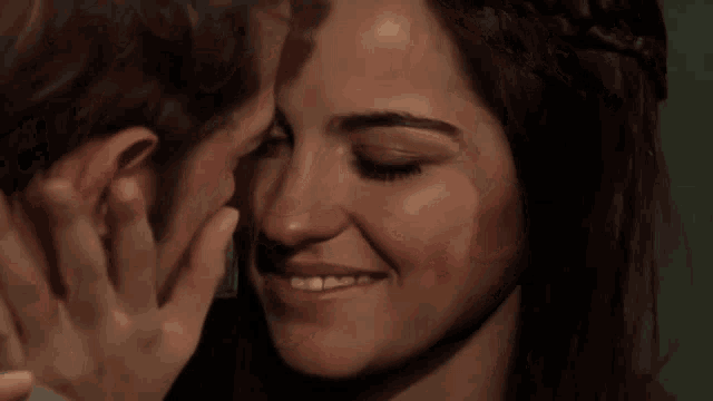 a man and a woman are kissing each other in a dark room