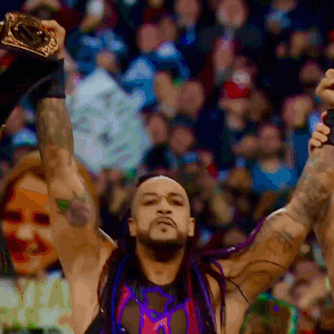 a man with purple hair is holding up a trophy
